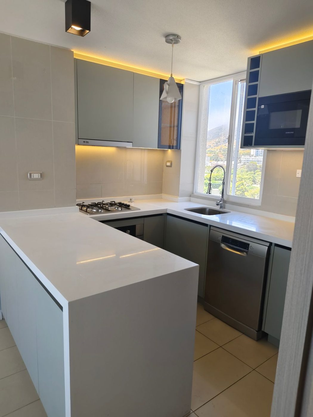 Cocina blanca de departamento con muebles a medida